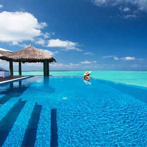 Velassaru Maldives - Luxury Maldives Honeymoon Packages - Water Suite woman in pool