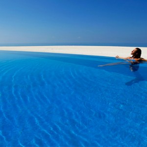 Velassaru Maldives - Luxury Maldives Honeymoon Packages - woman in pool