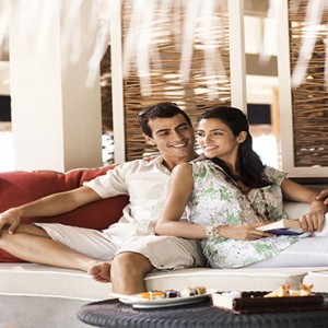 Vivanta By Taj - Coral Reef - Luxury Maldives Honeymoon Packages - Couple at the latitude