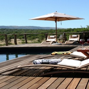 Pumba Private Game reserve - Luxury South Africa Honeymoon Packages - Bush Lodge Msenge Chalets exterior pool sun loungers and view