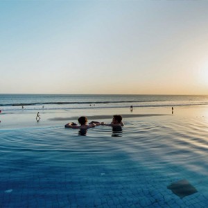 Legian Bali Seminyak - Luxury Bali Honeymoon Packages - couple in the pool