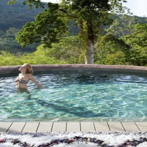 Keemala Phuket - luxury Thailand Honeymoon Packages - Women in tree house pool