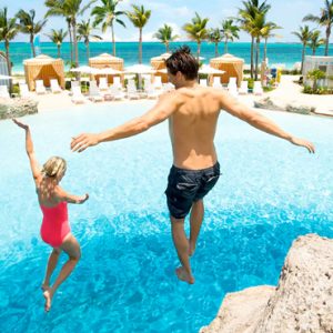 Bahamas Honeymoon Packages Grand Hyatt Baha Mar Couple Jumping In Pool