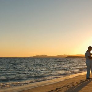 Mexico Honeymoon Packages Secrets Puerto Los Cabos Golf & Spa Resort Bride And Groom On Beach At Sunset