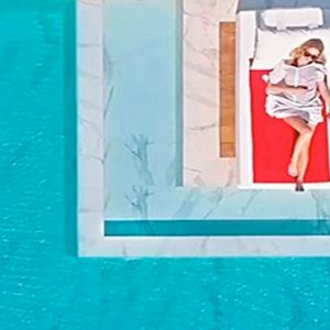 Couple Relaxing By The Pool Abaton Island Resort & Spa Greece Honeymoons