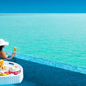 Woman Enjoying Floating Breakfast In Pool Pullman Maldives Maamutaa Resort Maldives Honeymoon
